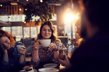 Girl in a coffeeshop with friends 