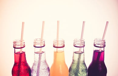 Colored Soft Drinks in Glass Bottles with Straws