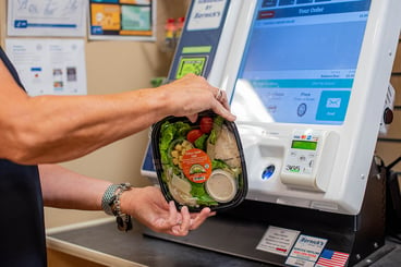 Customer purchasing a salad from the Micro Market self serve kiosk