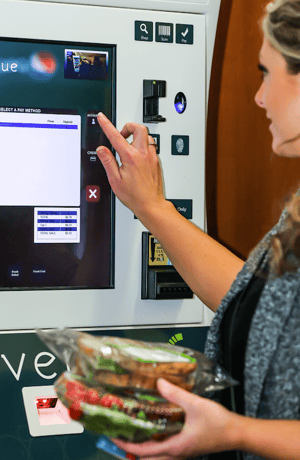 woman using micro market kiosk